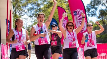 A group of women wearing pink at a fitness event