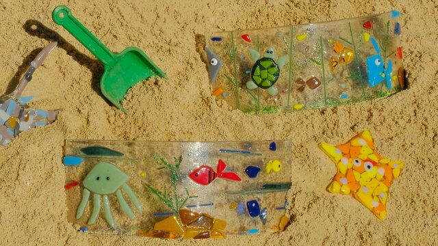 Coloured and shaped glass pieced together to resemble sea creatures