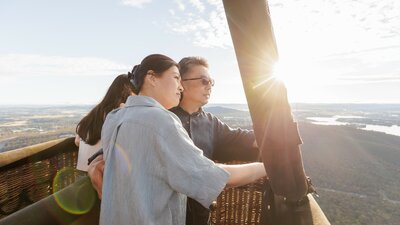A couple on a hot air balloon ride at sunrise