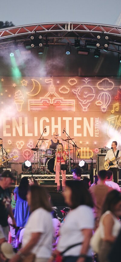 A crowd of people watching a concert on stage