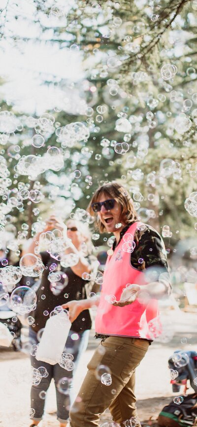 Bubbles floating around people at a lively event