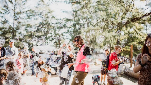 Bubbles floating around people at a lively event
