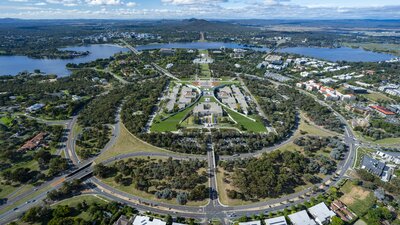 An aerial view of the Australian Parliament House building and surrounding region