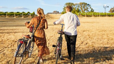 Two people with bikes at Clonakilla Winery