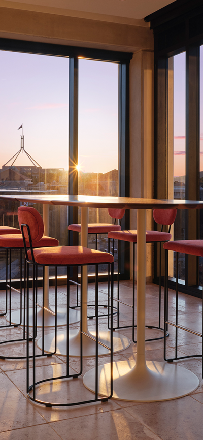 View from the rooftop Leyla bar in Canberra's National Triangle and Parliament House as the sun sets outside the windows. | © Romello Pereira