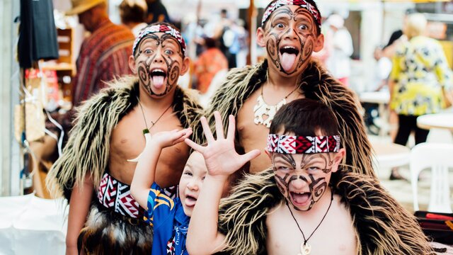 Three boys wearing a cultural costume