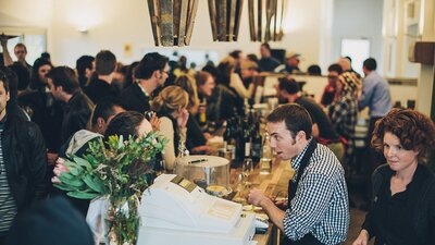 The bustling shop filled with customers and staff at Four Winds Vineyard.