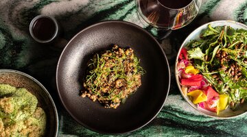 A selection of dishes and a glass of wine served at Monster Kitchen and Bar, located in NewActon.