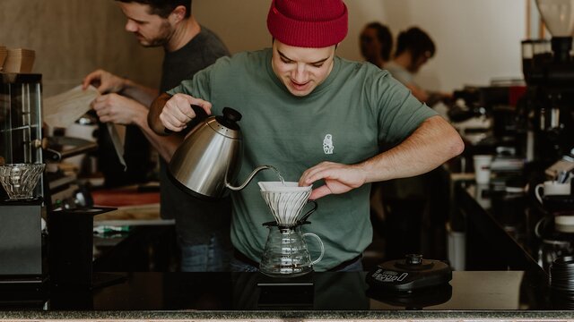 A barista pouring filter coffee at Rebrick Roastery.
