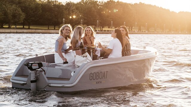 A group of friends enjoying their time on a GoBoat on the lake.