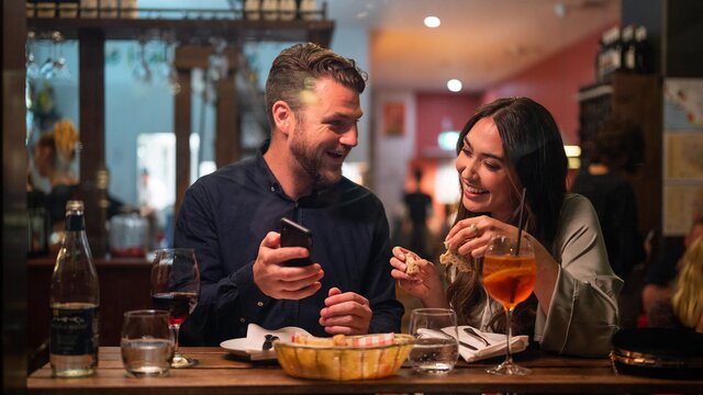 A couple enjoying a meal and wine at The Italian Place, a restaurant in Braddon.