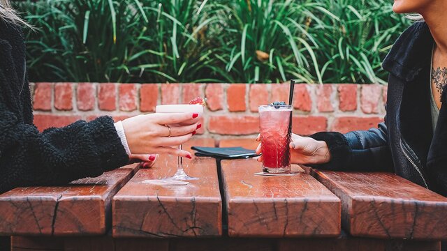 Two friends enjoying cocktails at Assembly, a restaurant and bar in Braddon.