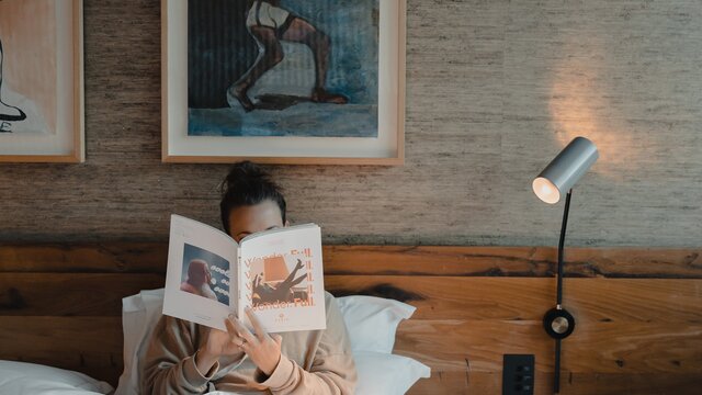 A woman reading in bed.