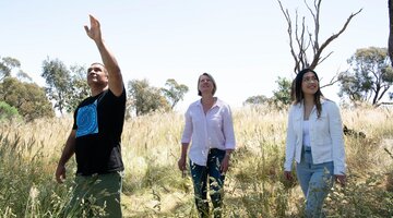 Man and two women walking through nature reserve