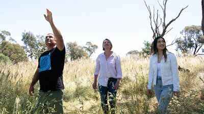 Man and two women walking through nature reserve