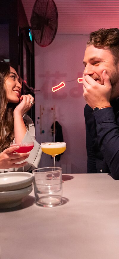 A couple enjoying cocktails at Lazy Su in Braddon.