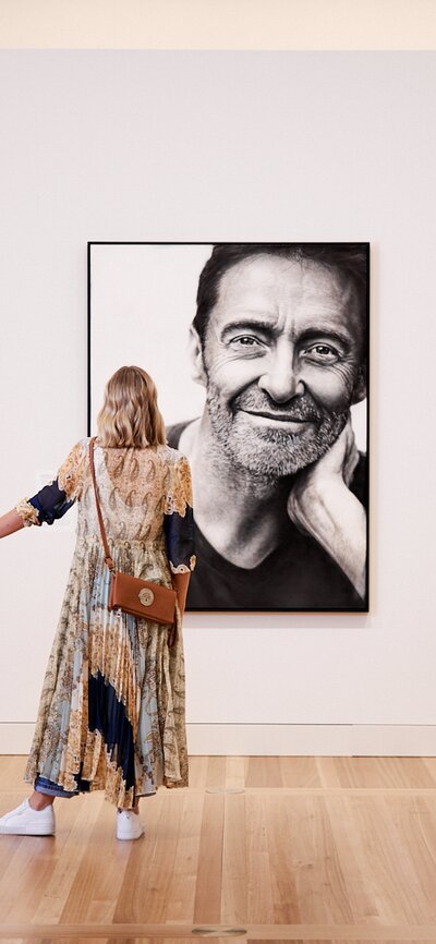 Mum and daughter looking at portrait of Hugh Jackman.