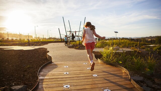 A child running on a path at the National Arboretum.