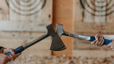Two axes in front of wooden targets