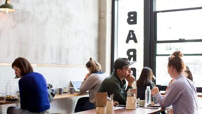 People enjoying their brunch meals and coffee at Barrio, a cafe located in Braddon.