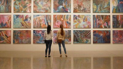 A couple looking at First Nations art at the National Gallery of Australia.