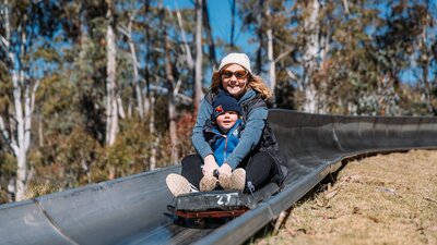Woman and child on slide.