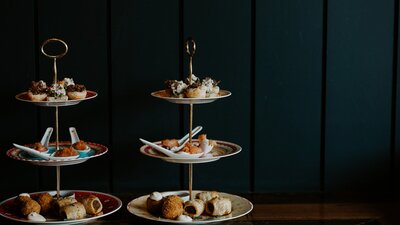 Tiered plates of food served at White Rabbit Cocktail Lounge as part of their high tea experience.