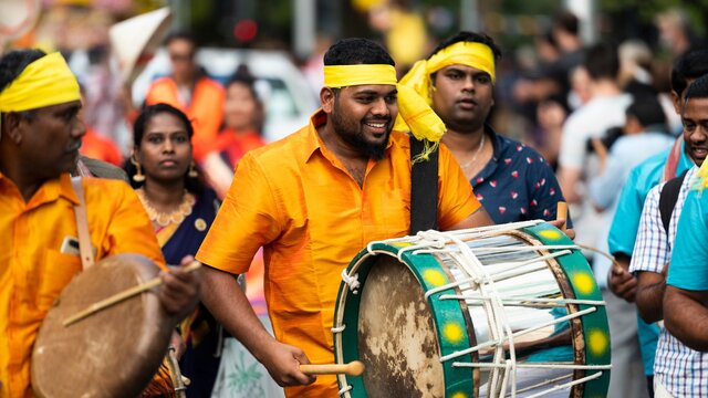 Man playing drums in a cultural costume