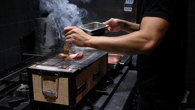 Chef preparing food at Mu Omakase