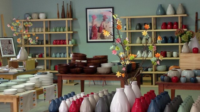 A shop full of ceramics sorted by colour.
