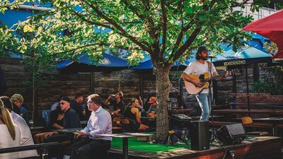 Musician playing live at Assembly Bar