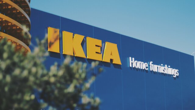 The blue exterior of an Ikea store with the yellow IKEA signage.