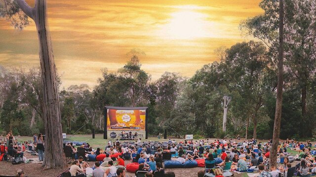 Crowd in park watching a film