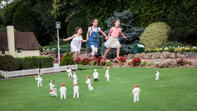 Kids running through Cockington Green Garden