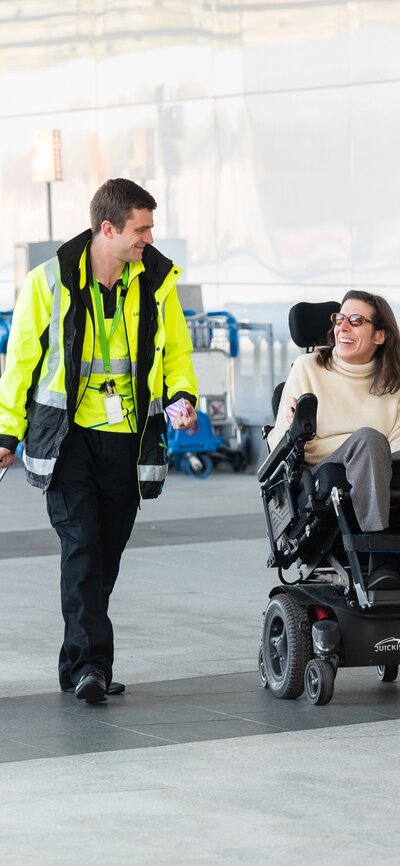 A wheelchair user being supported through their journey around Canberra Airport.