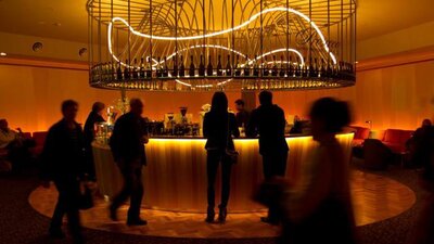 Movie-watchers gather around the bar before the film begins at Palace Electric Cinema.