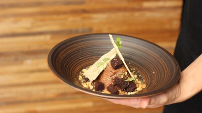 Staff holding dish at Vincent restaurant