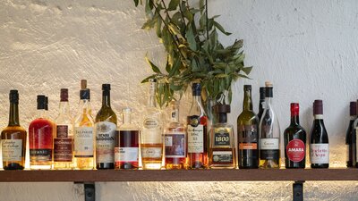 Drinks lined up in a row on a shelf