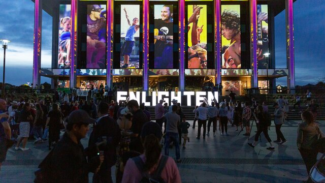 Large block letters spelling out Enlighten on the steps of the National Library of Australia building