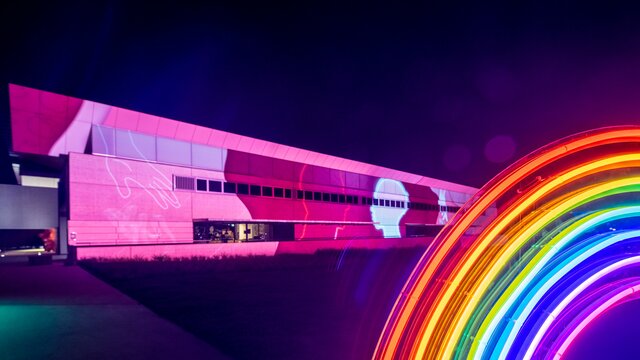 National Portrait Gallery illuminated with a projection and a rainbow installation in front of it