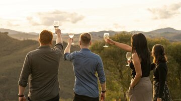 Four friends at a winery with a view of the mountains