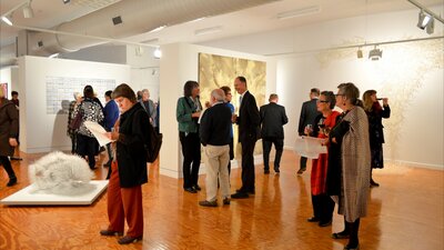 Visitors standing in an art gallery