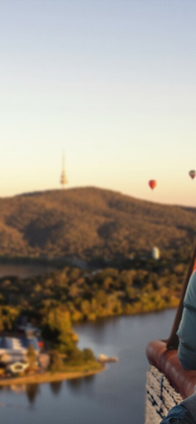 A man in a hot air balloon soaring across Canberra national attractions